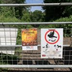 Photo of one of our branded signs attached to the gate, asking people to keep to paths