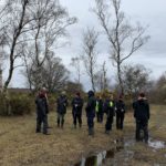 Photo of a group of wardens talking to the team from Marwell Wildlife.