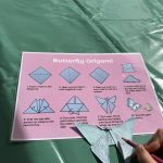 Photo of an origami butterfly with instructions on how to make it