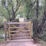 Photo of a wooden gate and bridge over a lake
